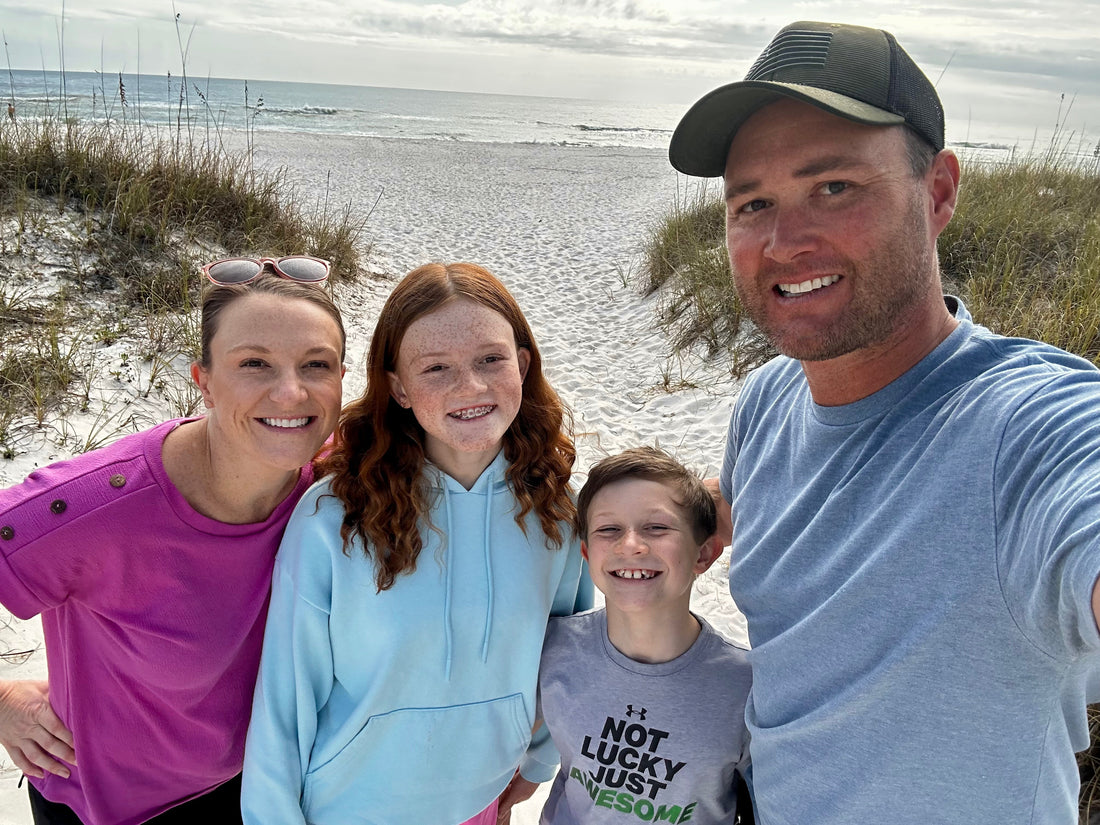 Heads and Toes owner and his family on a beach. 